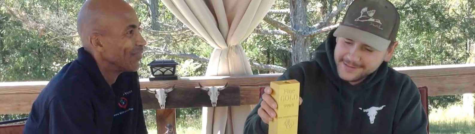 Garrett holding a check from a forgotten investment account located by WeFoundYou